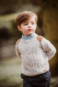 little boy in knitted jumper looking cute