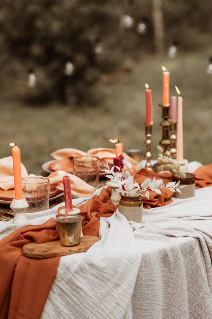 table decor, natural, rustic, burnt orange colours. Candles and earthenware.