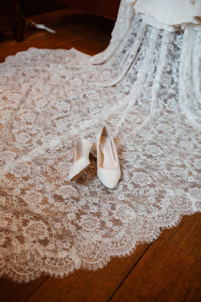 bridal shoes on lace veil