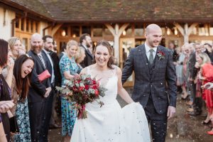 Rivervale Barn Wedding confetti bride and groom laughing