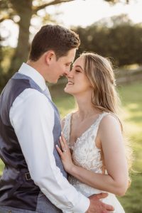 bride and groom embracing. Golden hour light.